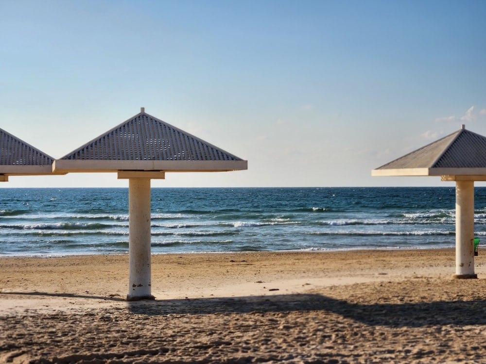 a row of umbrellas sitting on top of a sandy beach