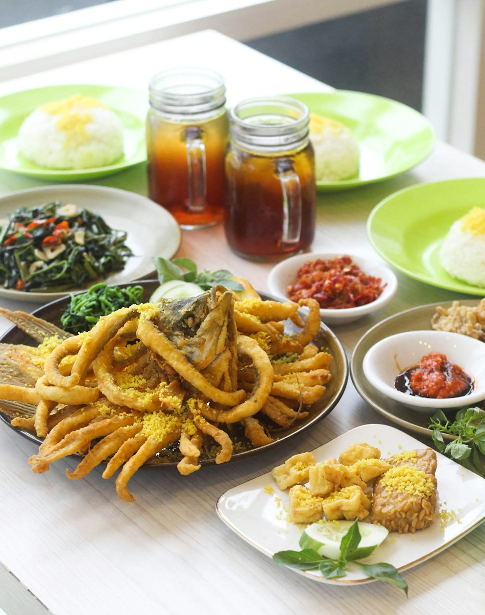 a table topped with plates of food and drinks