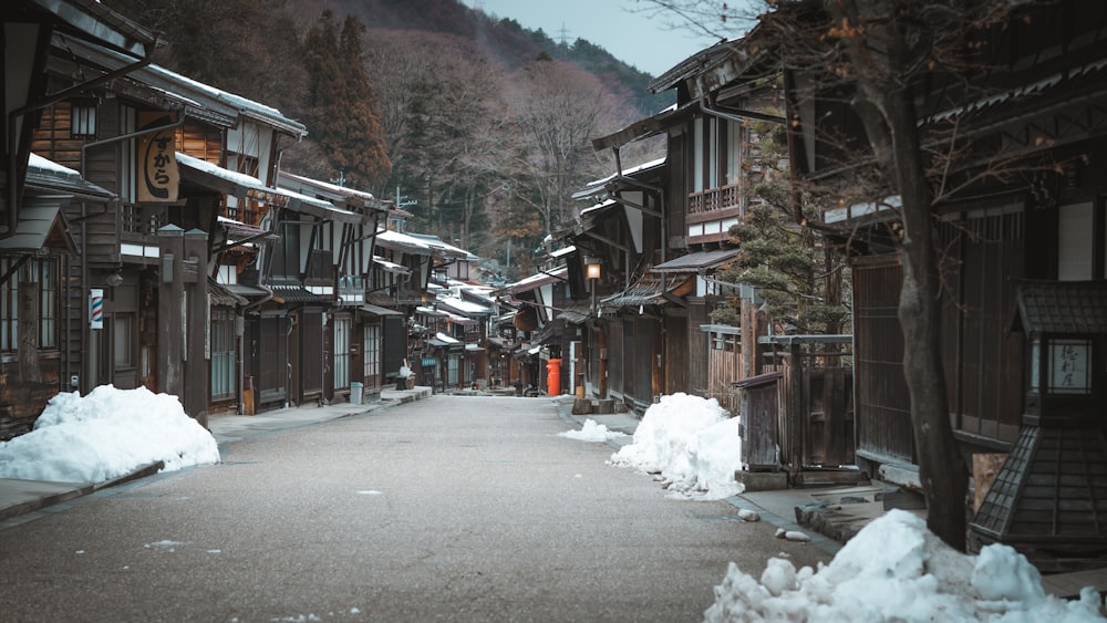 a narrow street with snow on the ground