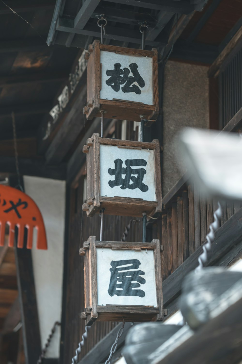 a group of signs hanging from the side of a building