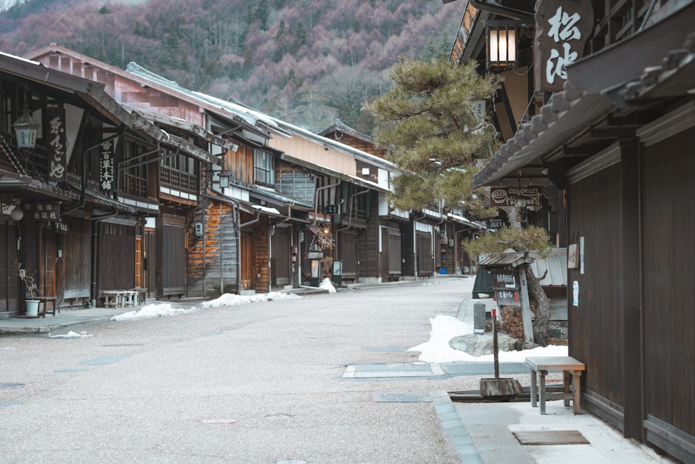 a street lined with wooden buildings in the snow
