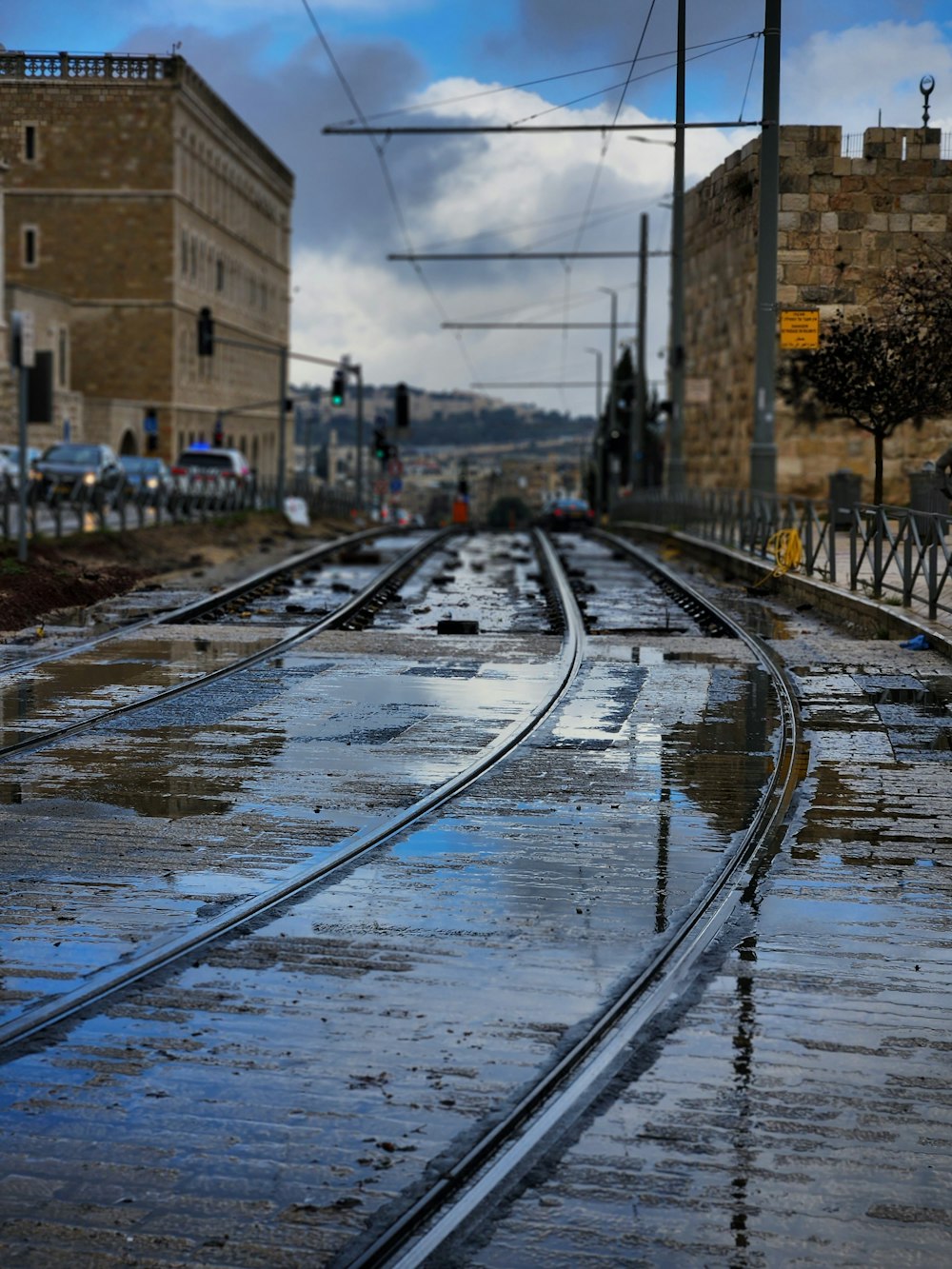 a train track that is wet from the rain