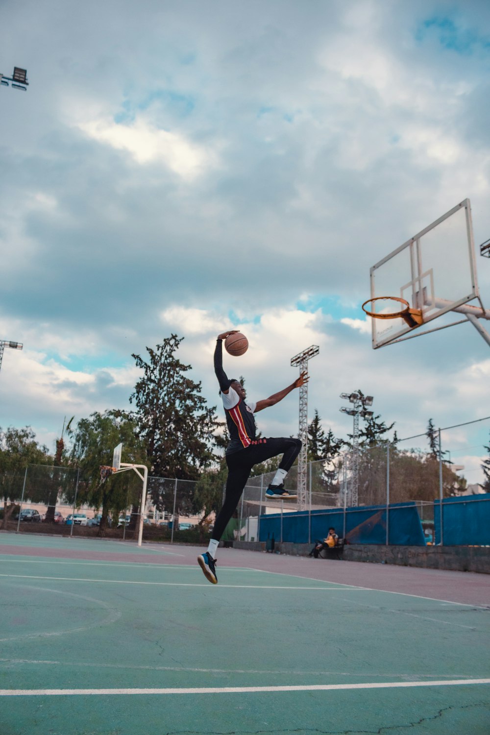 a person jumping up in the air to dunk a basketball