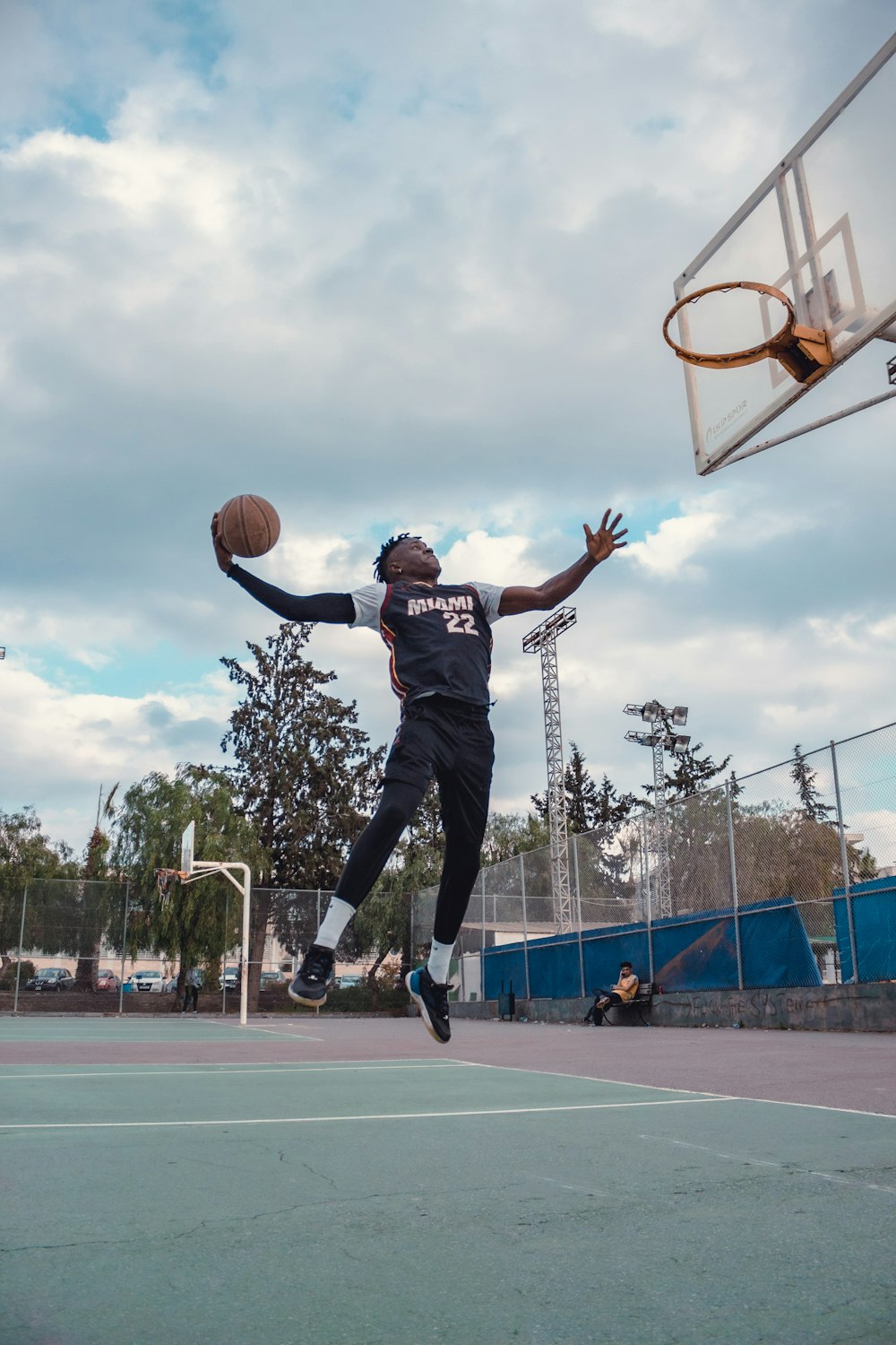 a man jumping up into the air to dunk a basketball