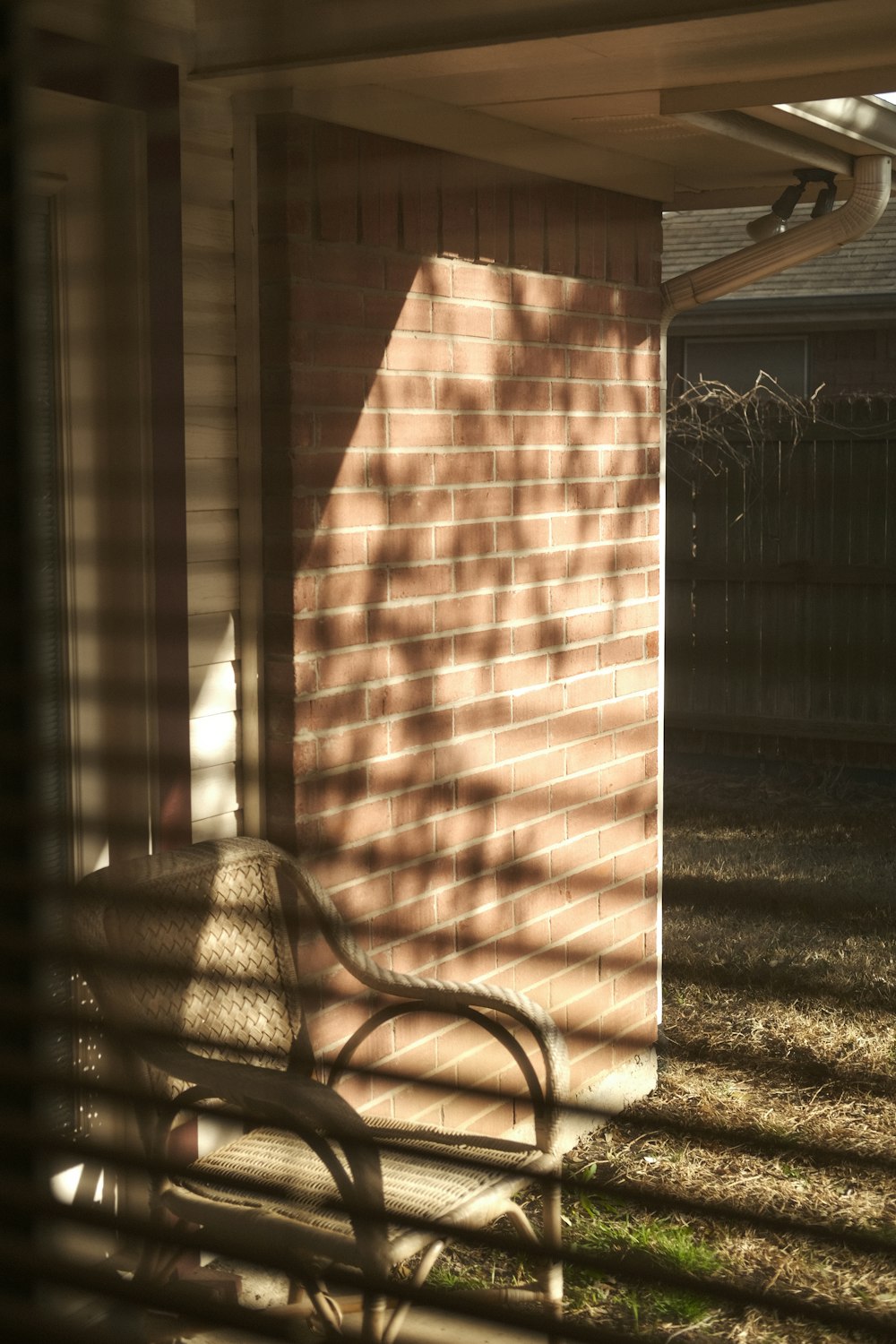 a wooden bench sitting in front of a brick building