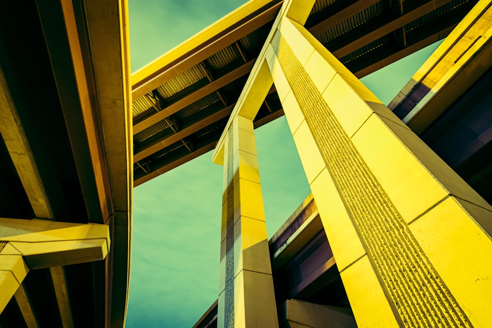 a tall yellow building with a sky in the background