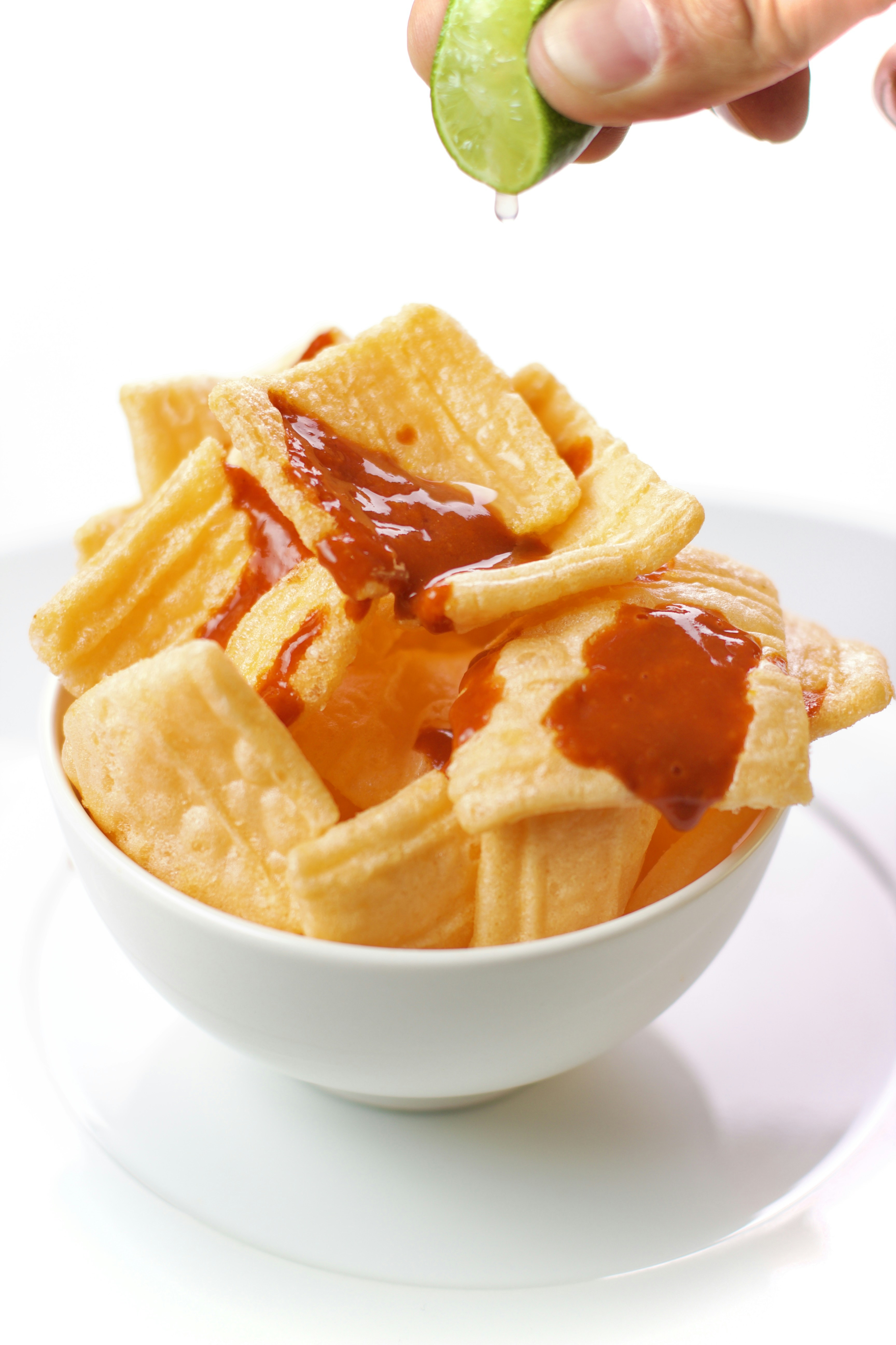 a bowl filled with waffles covered in ketchup