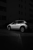 A stylish car parked in an urban environment, highlighting its features.