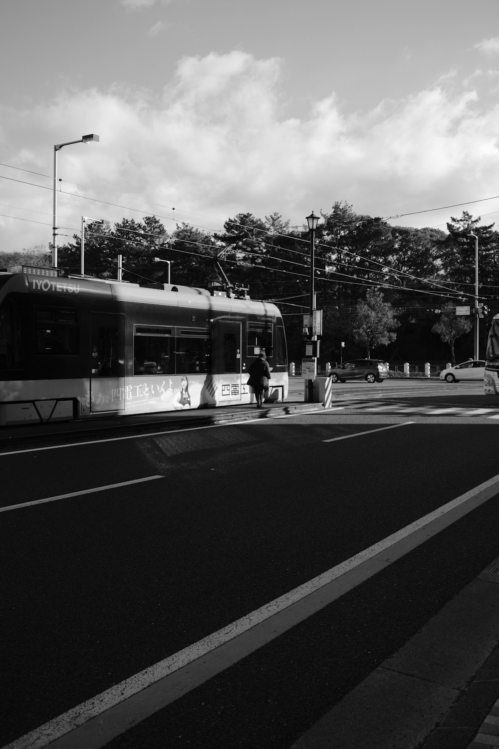 a black and white photo of a bus on a street