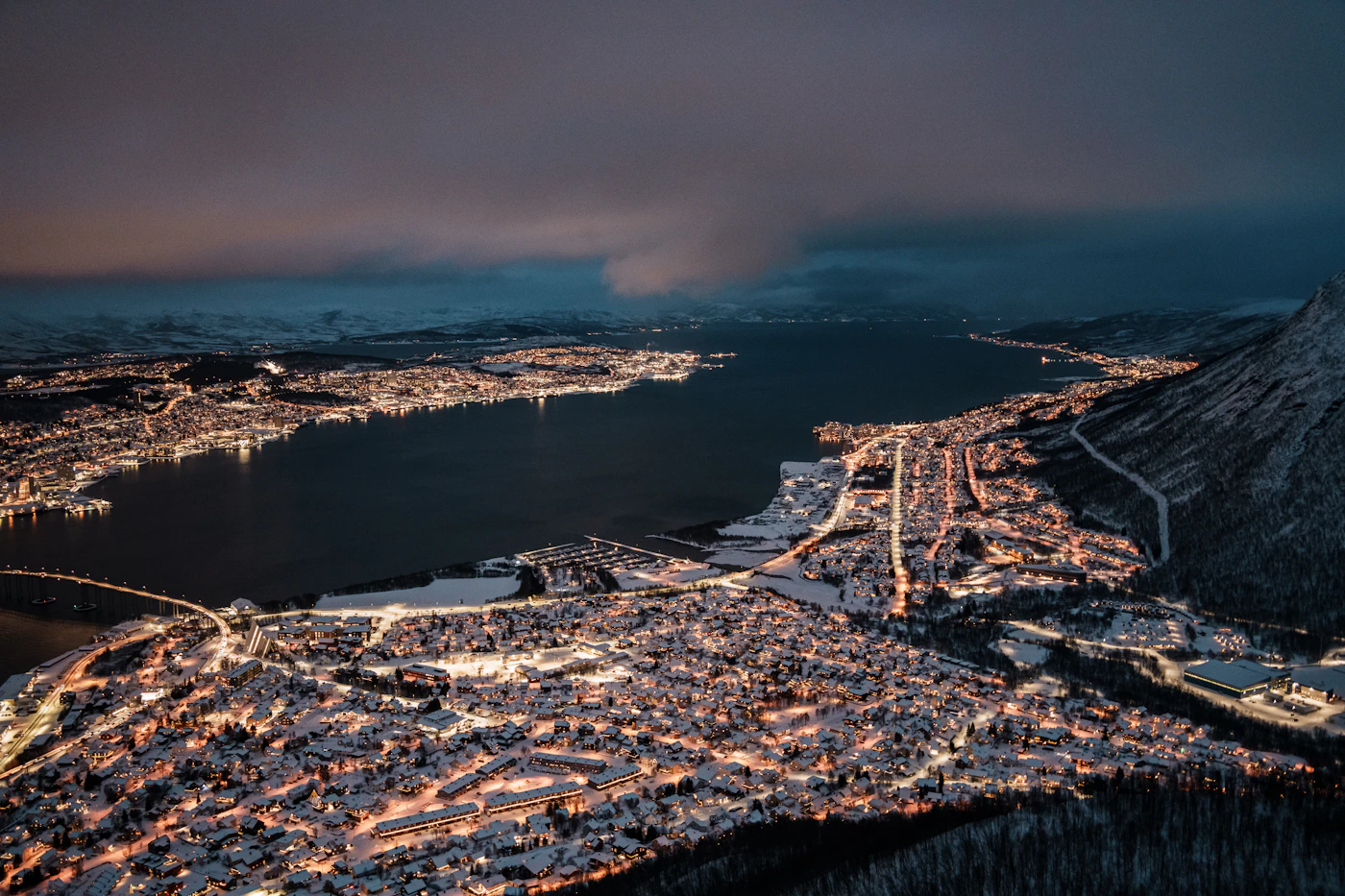 Tromsø glowing beside the water during Arctic winter