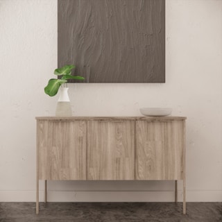 A modern sideboard featuring clean lines and a matte finish, styled with minimalist decor.