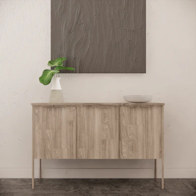 A clean-lined sideboard in muted olive tones, perfectly balancing function and subtle design.