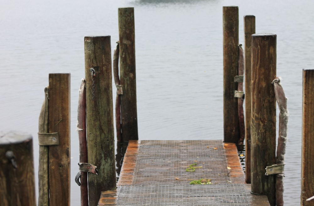 a wooden dock with a boat in the water