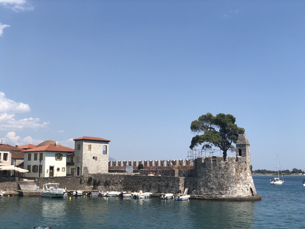 a castle on the water with boats in the water