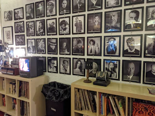 A gallery wall filled with framed photos and videos of past projects.