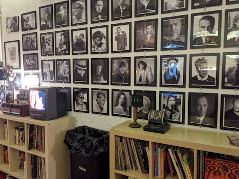 A gallery wall filled with framed photos and videos of past projects.
