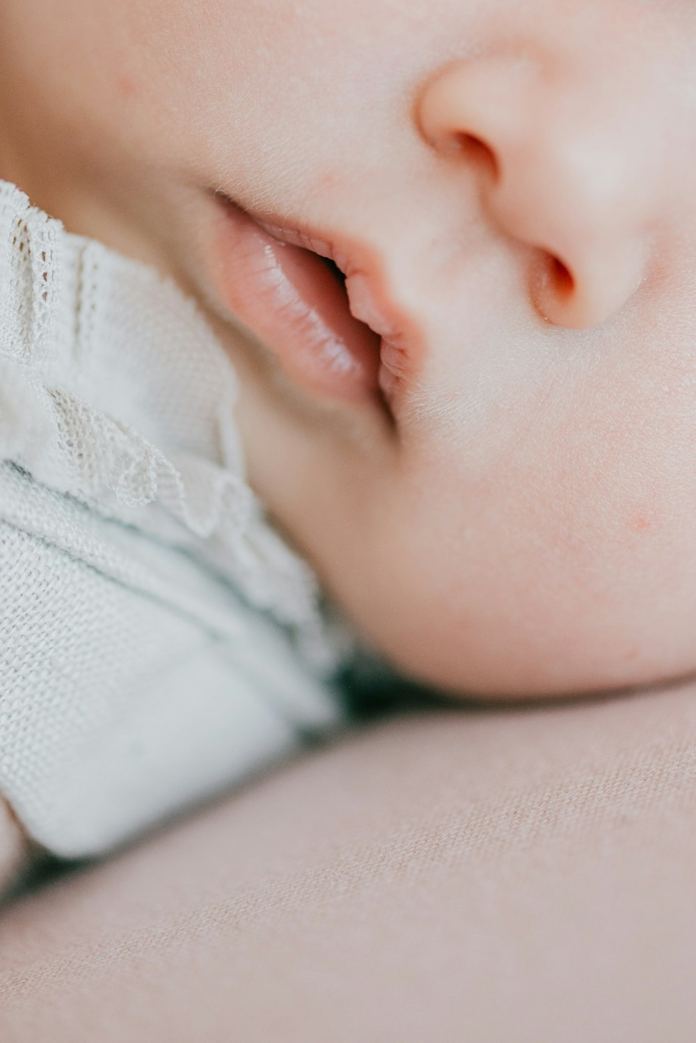 a close up of a baby laying on its side