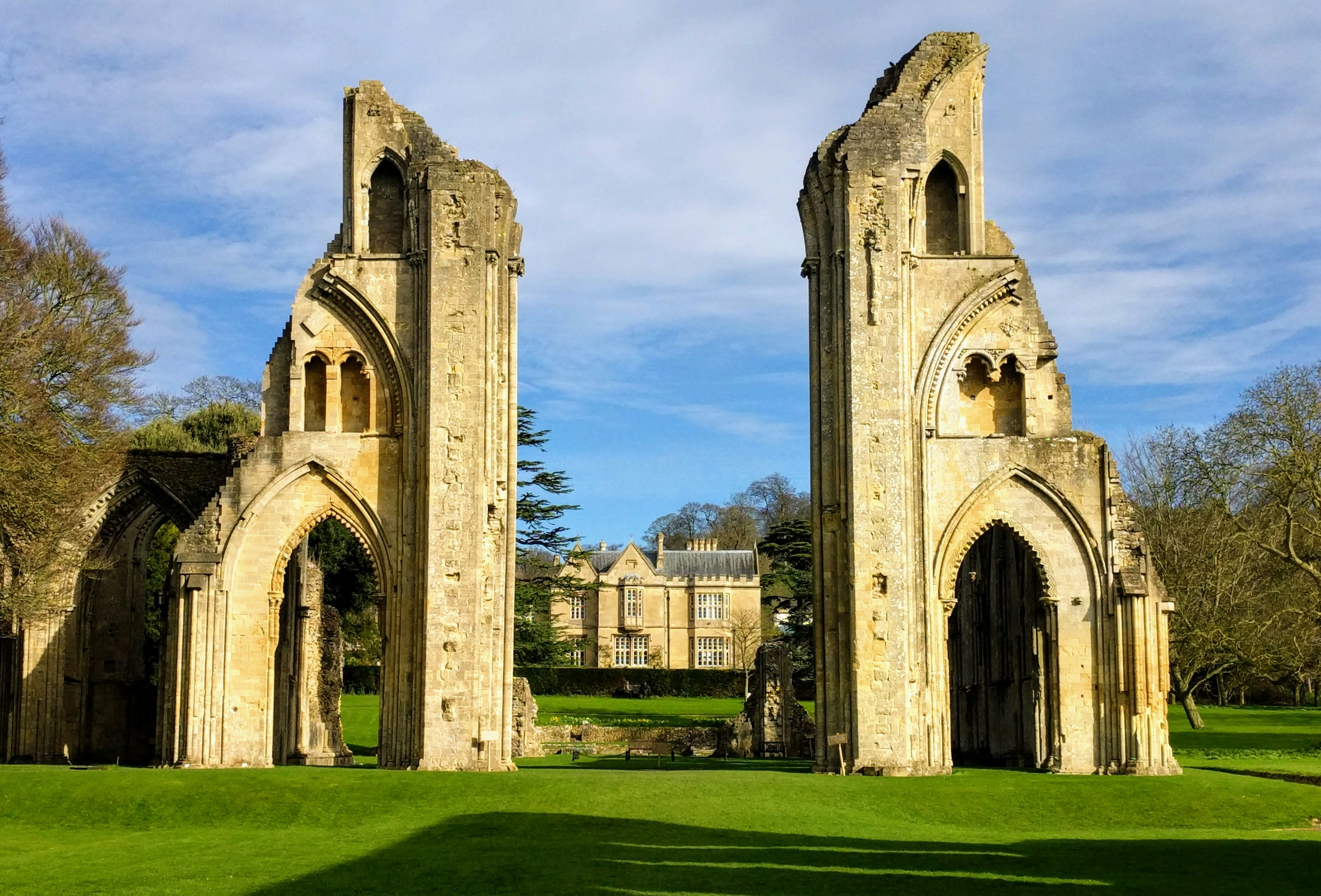 a large stone building sitting on top of a lush green field