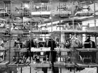 Display of various sewing machine models and garment accessories in a showroom.