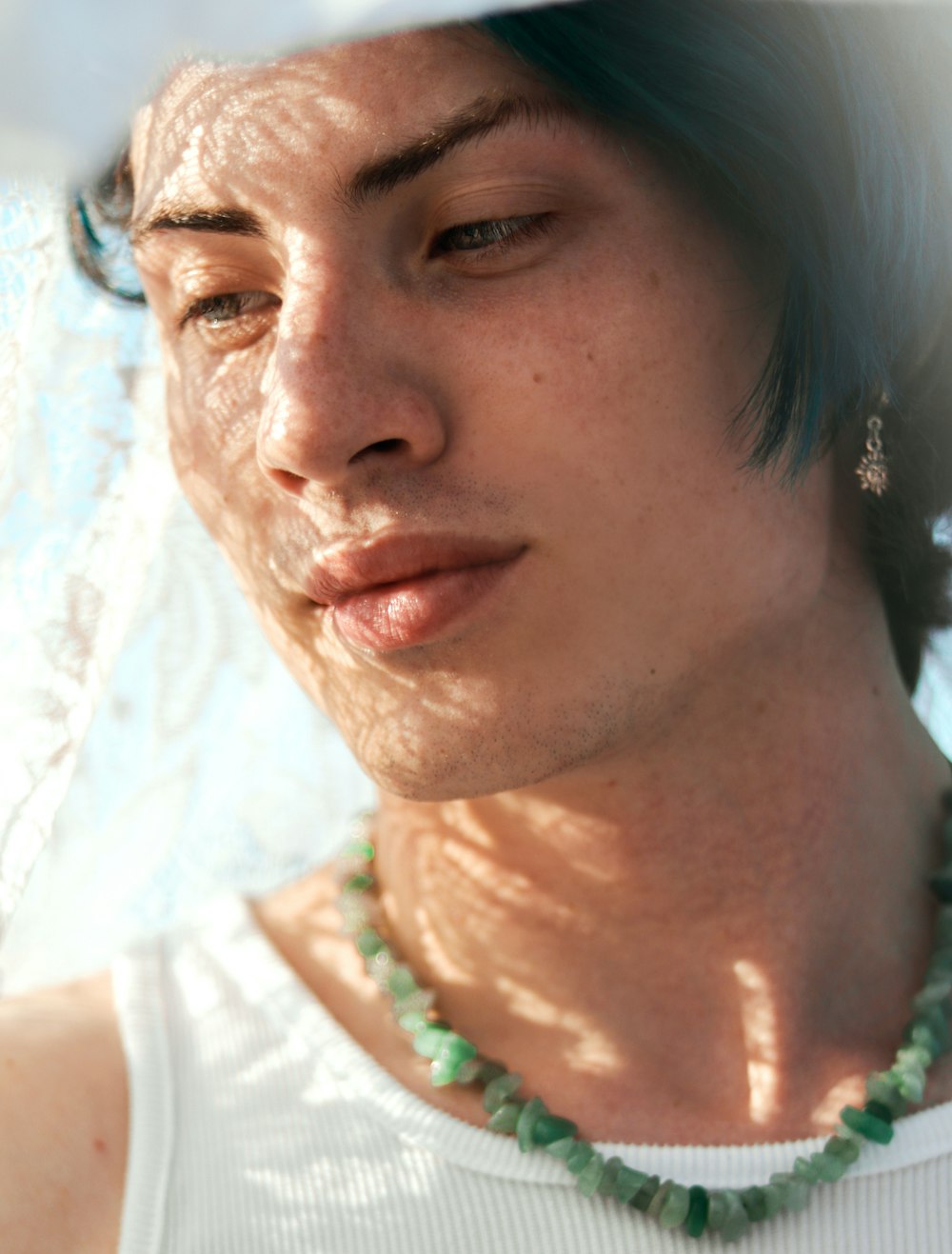 a close up of a person wearing a necklace