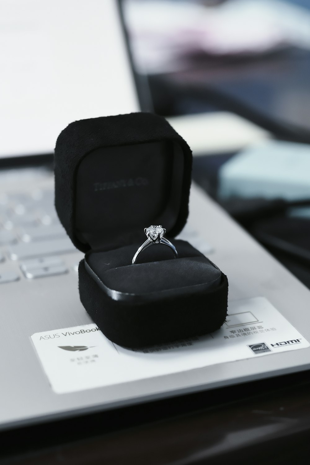 a ring sits on top of a laptop computer