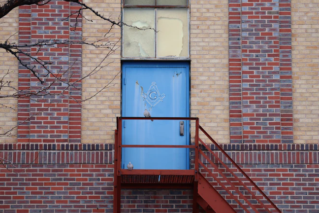 The grand entrance of Finsbury Archers Lodge No. 5466, adorned with Masonic symbols.