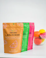 three bags of fruit sitting on top of a counter