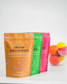 three bags of fruit sitting on top of a counter