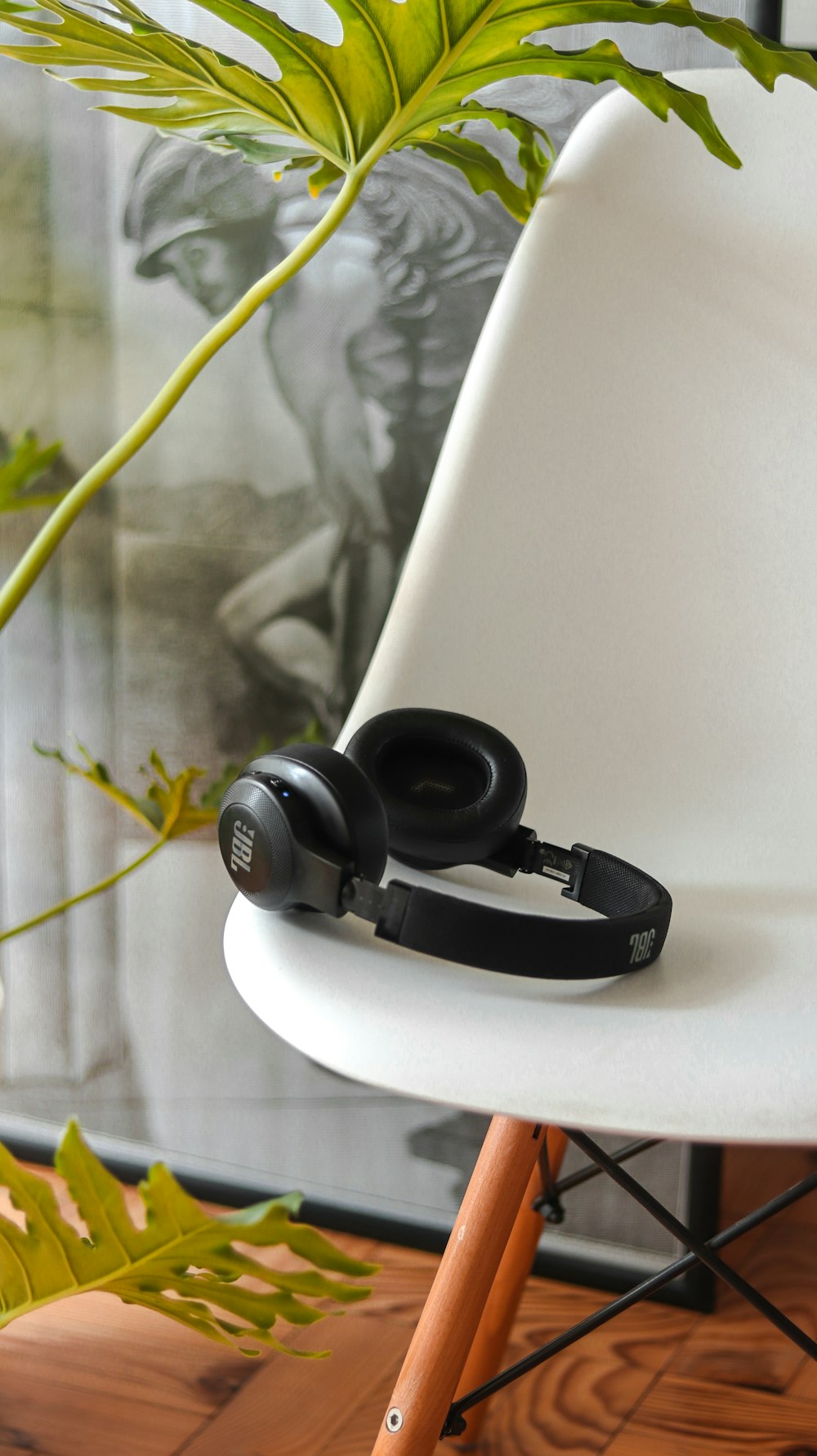 a pair of headphones sitting on top of a white chair