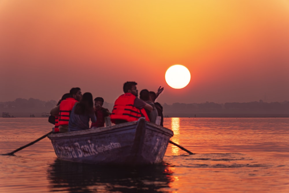 a group of people in a boat on a body of water