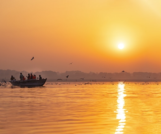 a group of people on a boat in the water