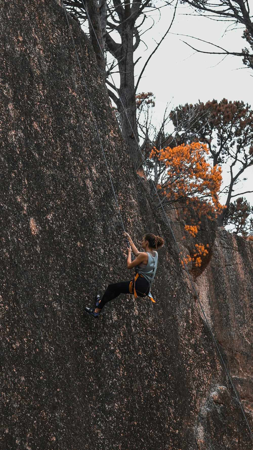 a man climbing up the side of a mountain
