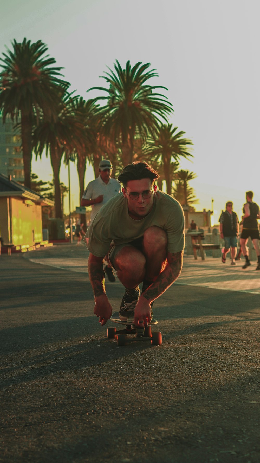 a man riding a skateboard down a street