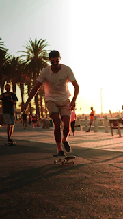 A skater cruising along a sunlit Baja California waterfront boardwalk, with waves breaking in the background under a vibrant sky.