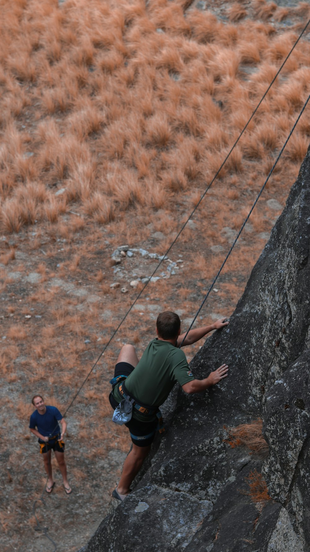 a man climbing up the side of a mountain