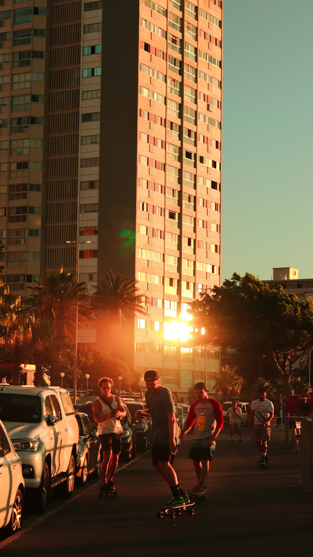 a group of people riding skateboards down a street