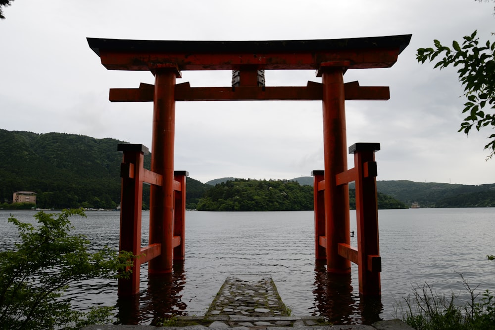 a large body of water next to a red gate