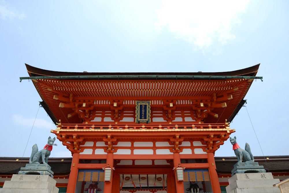 a tall red building with a sky in the background