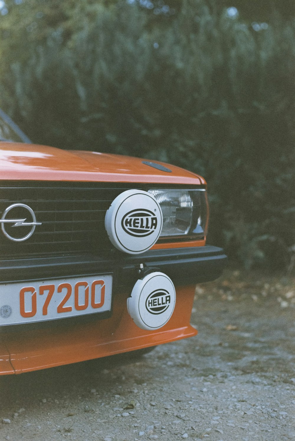 a close up of the front of an orange car