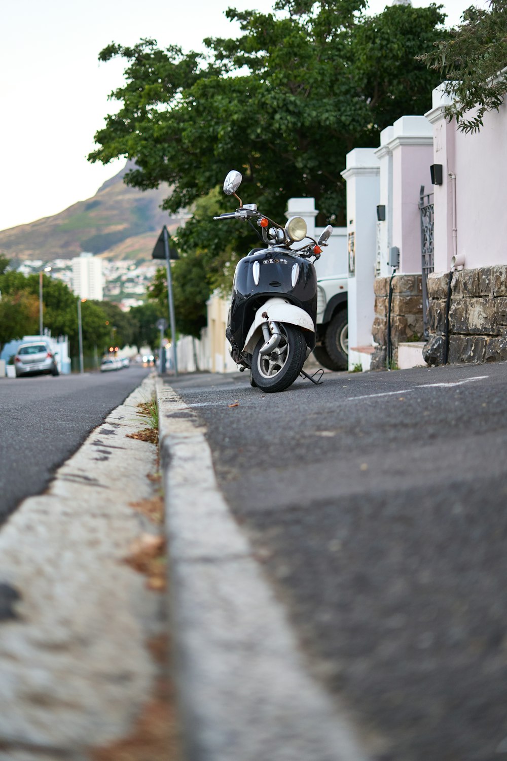 a motor scooter parked on the side of the road