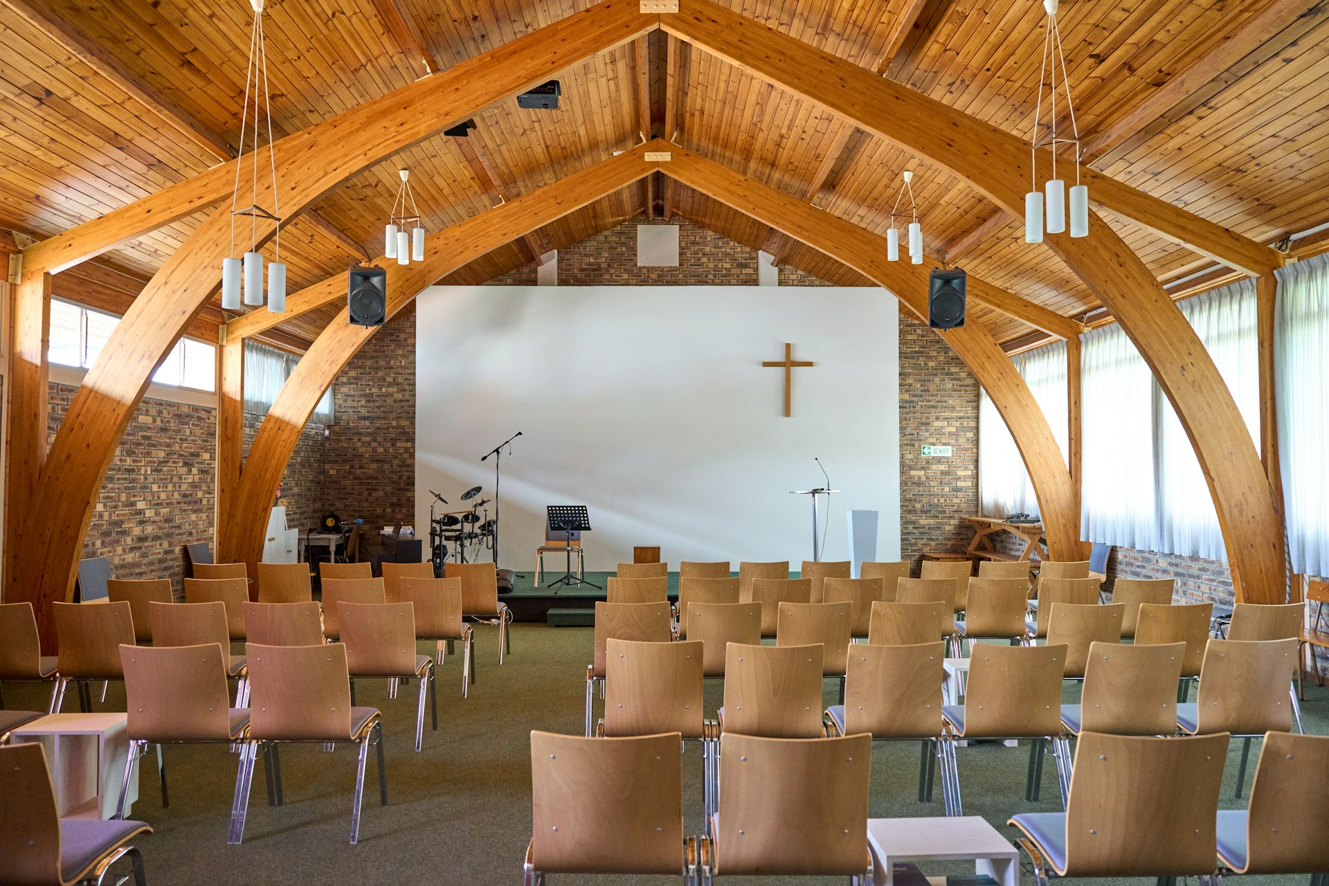 An empty church with a cross on the wall