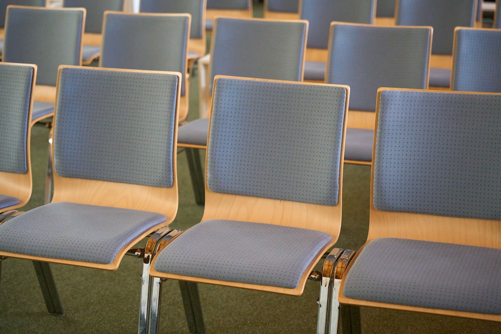 a row of blue chairs sitting in a room