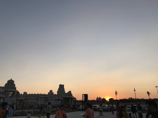 Sunset view at Tanah Lot Temple with visitors admiring the iconic sea temple silhouette.