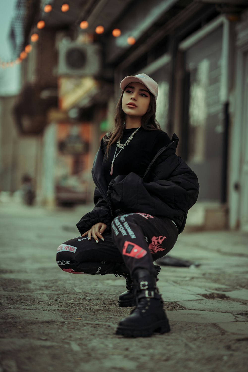 a woman sitting on the ground with her legs crossed