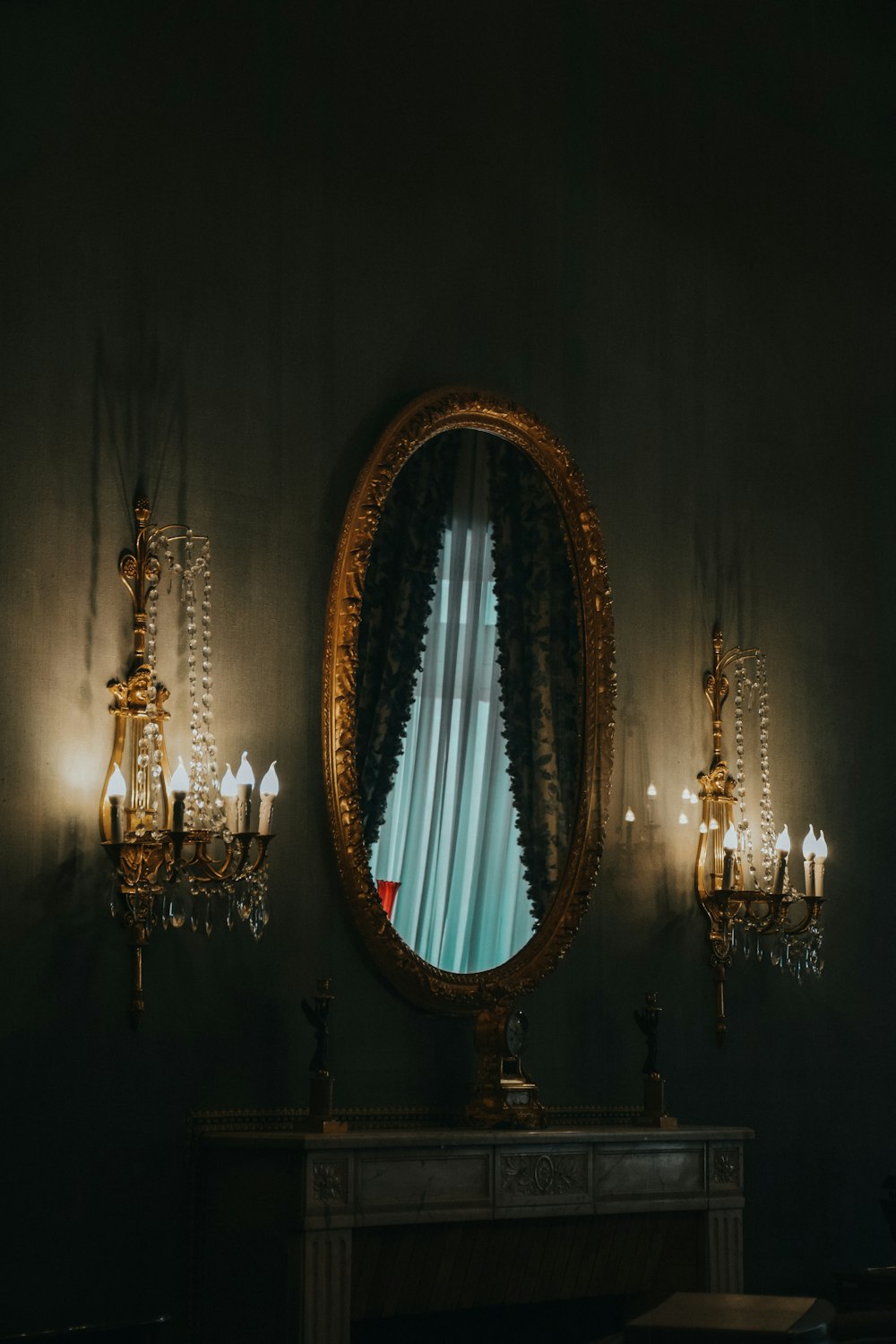 a table with a mirror and a chandelier