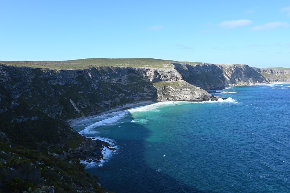 a large body of water next to a cliff