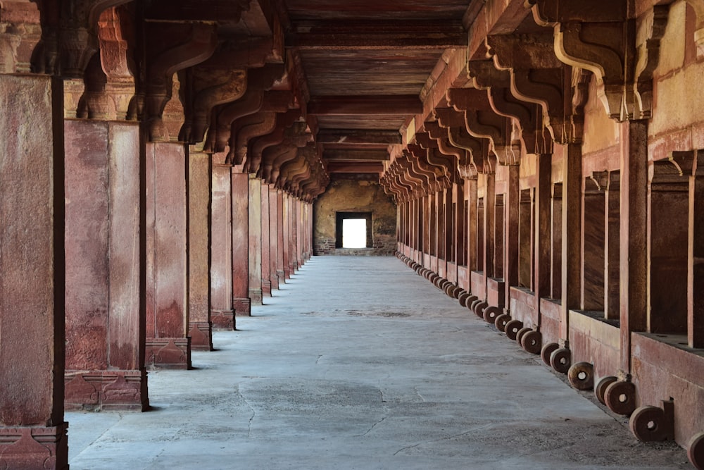 a long hallway with a bunch of urinals in it