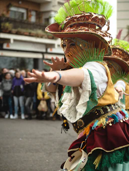 a woman in a costume is dancing in a parade