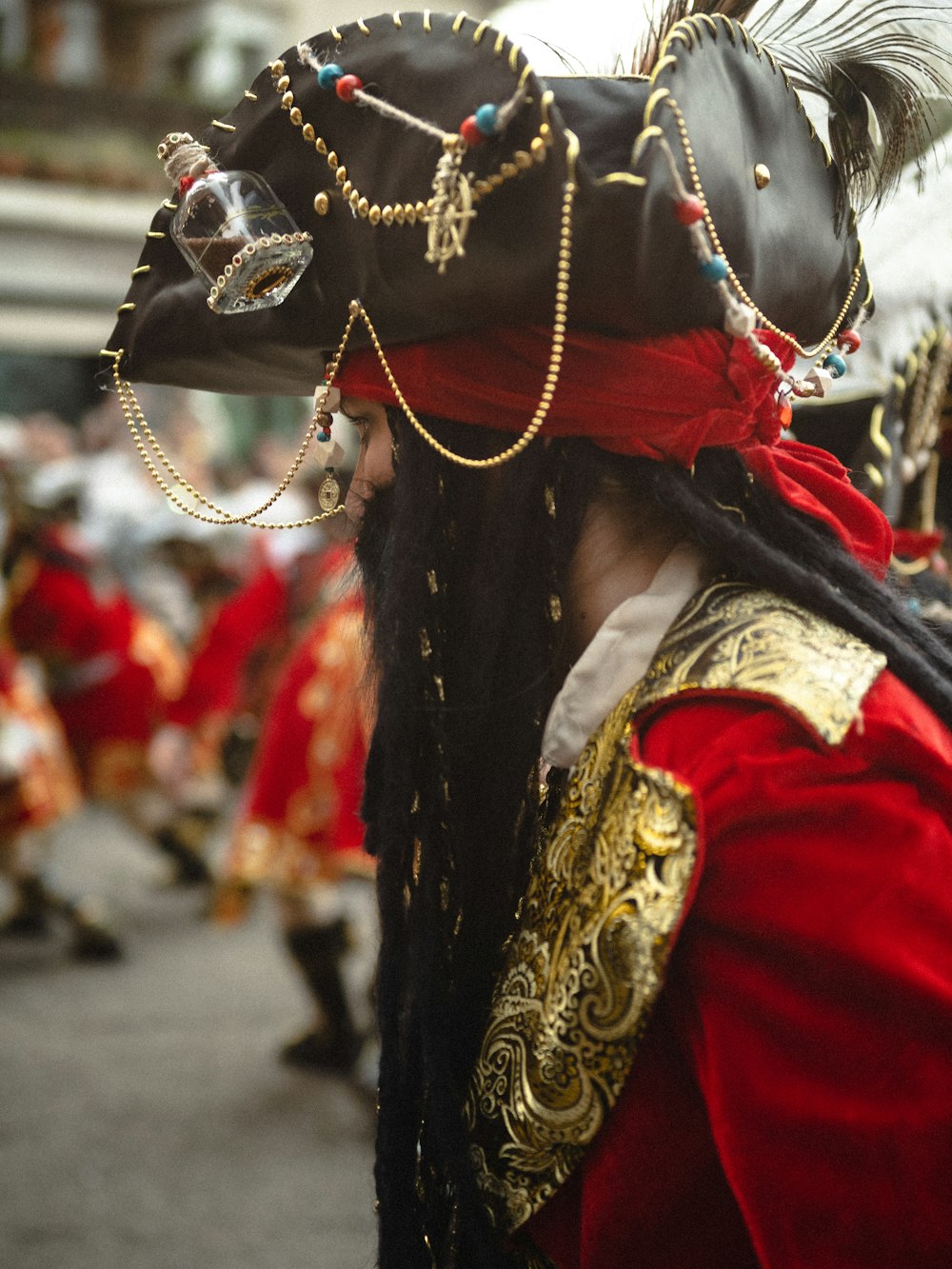 a man wearing a pirate costume and a black hat