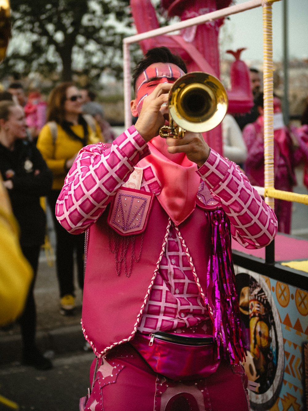 a man in a pink suit playing a trumpet